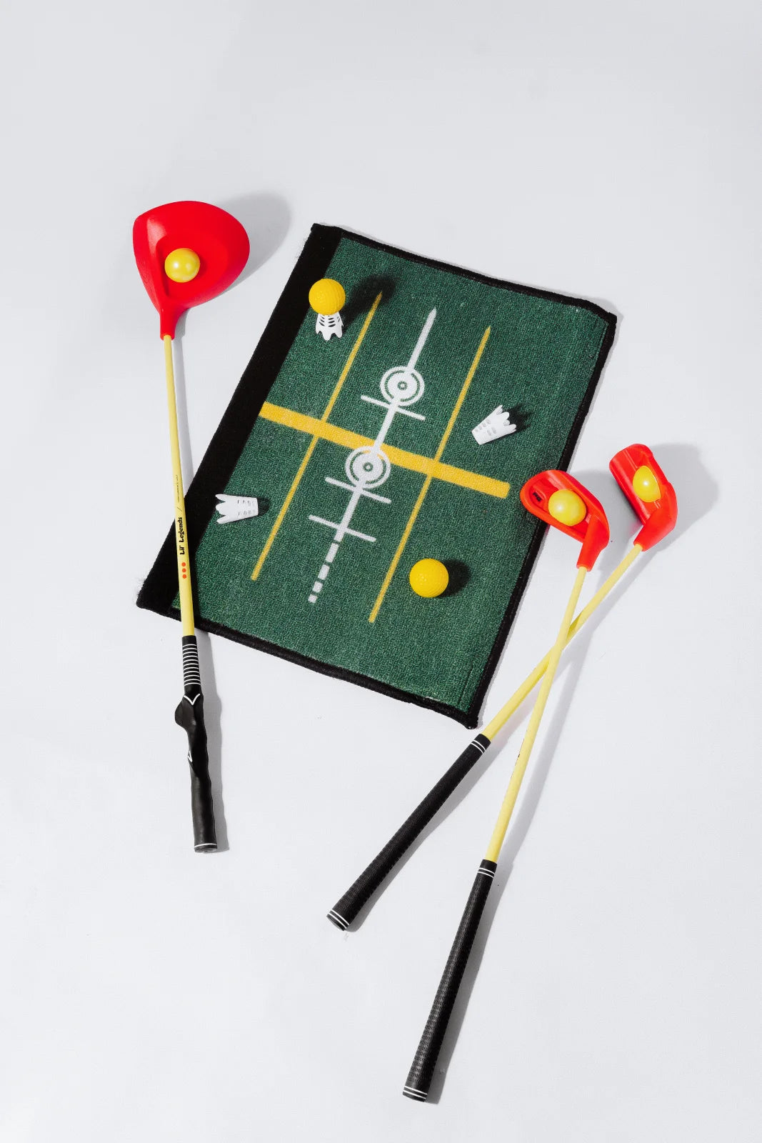 The complete Lil’ Legends Learning System: driver, iron, putter, See & Stand Mat that doubles as a carry bag, foam balls, and tees.
